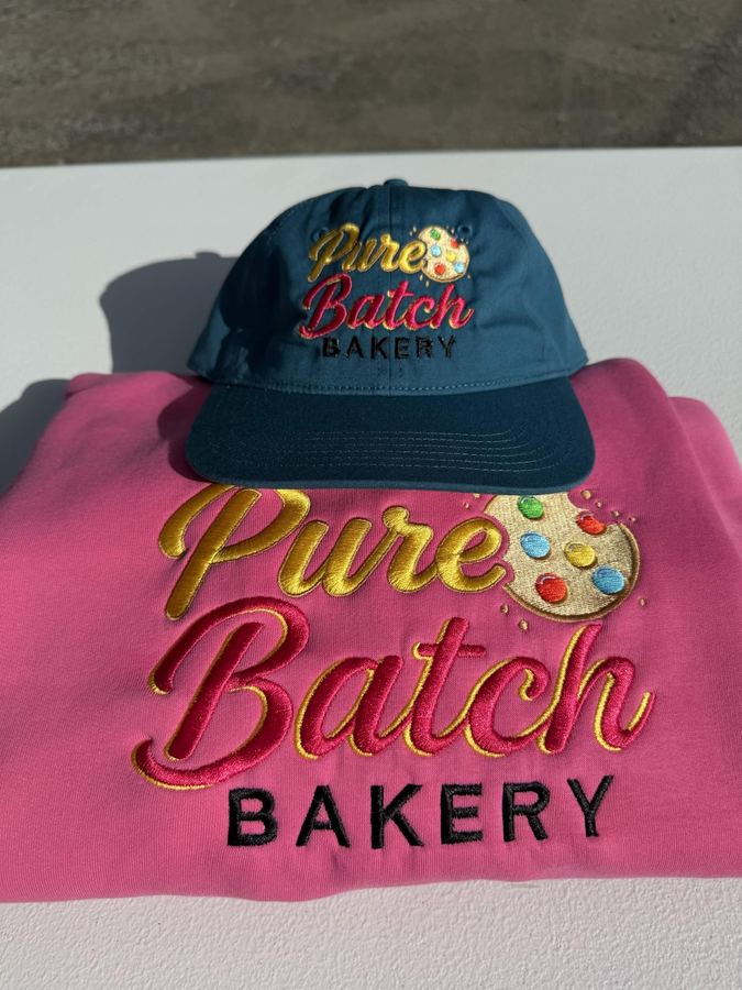 Business logo set: bakery branding machine embroidered in 3D satin stitch on a teal cap and pink crewneck